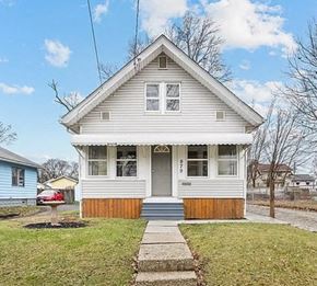 Akron house for rent - A small house with a grey front and a wooden porch.