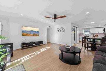 Phoenix apartment for rent - A living room with a black coffee table and a painting on the wall.