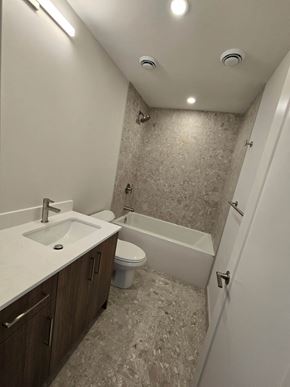 Ottawa apartment for rent - A bathroom with a sink, toilet and bathtub.