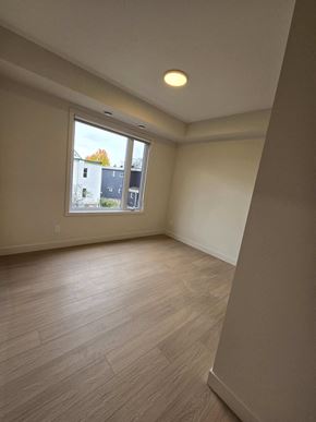 Ottawa apartment for rent - A room with a window and wooden flooring.
