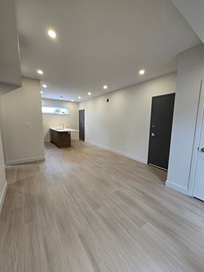 Ottawa apartment for rent - A room with light wood flooring and white walls.