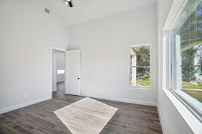 Horseshoe Bay house for rent - A room with a rug on the floor and a window showing a view of trees.