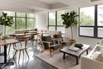 Columbus apartment for rent - A living room with a large window and a variety of chairs and tables.