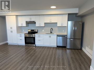 Aylmer townhouse for rent - A modern kitchen with white cabinets and stainless steel appliances.