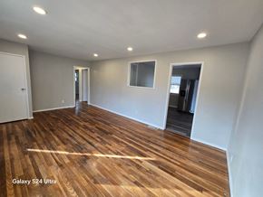 Florissant house for rent - A room with wooden flooring and white walls.