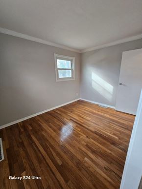 Florissant house for rent - A room with wooden flooring and a window.