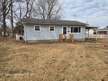 Florissant house for rent - A house with a grey roof and a white fence.