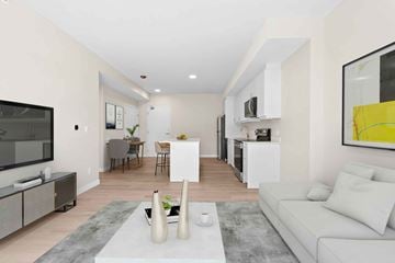 Napanee apartment for rent - A modern living room with a white couch and a grey rug.