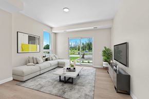 Napanee apartment for rent - A modern living room with a white sofa, a grey rug, and a large window.
