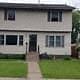 South Saint Paul house for rent - A white house with a black door and windows.