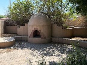 Chandler house for rent - A round structure with an arched doorway is surrounded by a wall and a paved courtyard.
