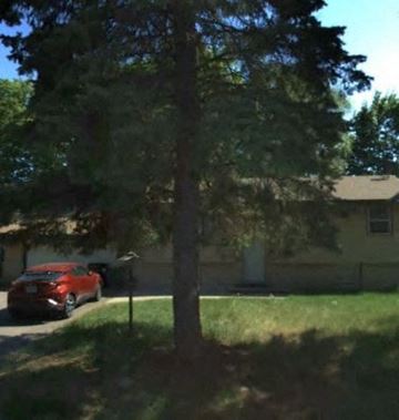 Spring Lake Park house for rent - A red car is parked on the side of a street.