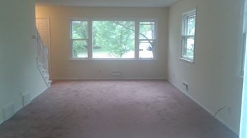 Anoka house for rent - A room with a carpeted floor and a window.