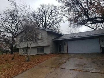 Coon Rapids house for rent - A house with a grey roof and a grey garage door.