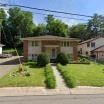 Columbia Heights apartment for rent - A house with a green lawn in front.
