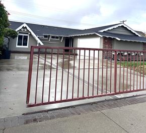 Ontario house for rent - A house with a grey roof and a red gate.