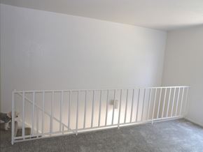 Dallas apartment for rent - A white baby crib in a room with a grey carpet.