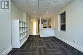 Hamilton apartment for rent - A long hallway with a carpeted floor and white walls.