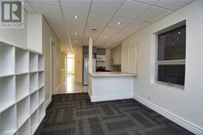 Hamilton apartment for rent - A long hallway with a carpeted floor and white walls.
