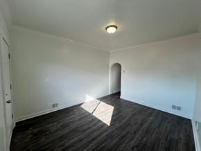 Glassport house for rent - A room with a wooden floor and a light on the ceiling.