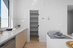 St. Albert apartment for rent - A kitchen with a white counter and a white chair.