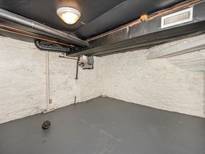 Frederick house for rent - A room with a white wall and a black pipe running along the ceiling.