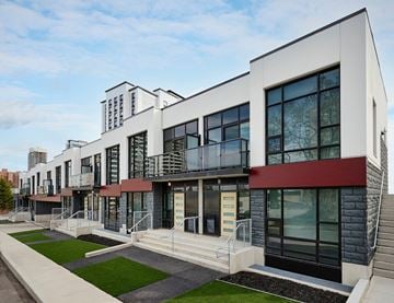Hamilton apartment for rent - A modern building with a red awning and a balcony.