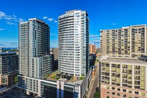 Hamilton apartment for rent - A cityscape with three tall buildings, one with a green roof.