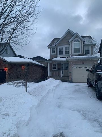 Guelph house for rent - A house with a snow-covered driveway in front.