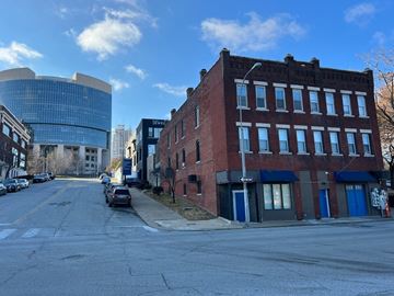 Kansas City apartment for rent - A street view of a city with a red brick building on the right.