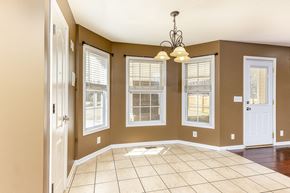 Clarksville house for rent - A room with brown walls and a white door.