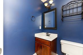 Clarksville house for rent - A bathroom with blue walls and a white sink.
