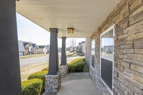 Clarksville house for rent - A porch with a stone pillar and a light on it.