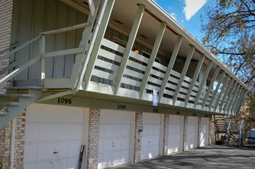 Lakewood apartment for rent - A building with a balcony and garage doors.