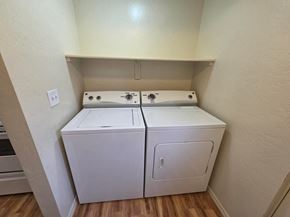 Boise triplex for rent - A white dryer and washer in a small room.