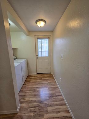 Boise triplex for rent - A hallway with a white door and a light on the ceiling.