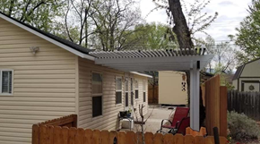 Boise triplex for rent - A house with a wooden fence and a patio area.
