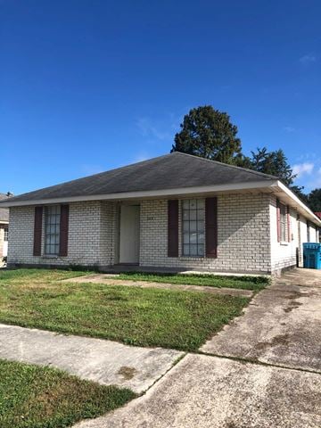 Destrehan apartment for rent - A small house with a grey roof and a blue trash bin.