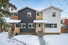 Edmonton apartment for rent - A house with a grey and white exterior is surrounded by snow.