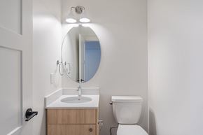 Edmonton apartment for rent - A bathroom with a sink, mirror, and toilet.