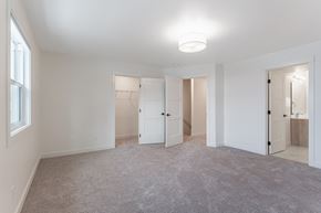 Edmonton apartment for rent - A spacious room with white walls and a carpeted floor.