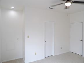 Dallas apartment for rent - A room with a ceiling fan and two doors.