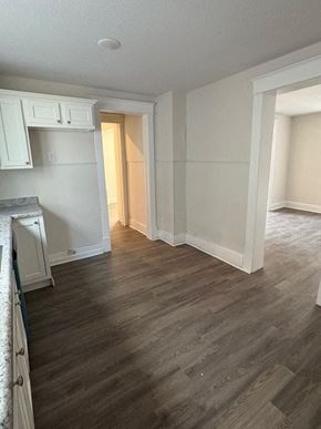 Lima house for rent - A room with wooden floors and white walls.