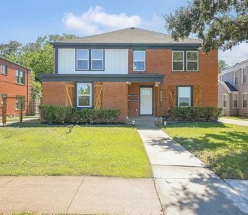 Houston apartment for rent - A two-story brick house with a front porch.