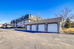 Aurora apartment for rent - A large building with a garage door in front.