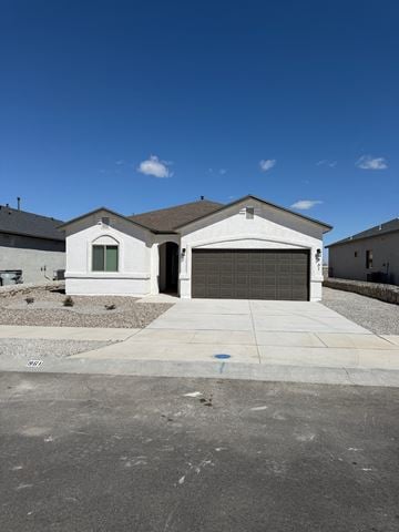 El Paso house for rent - A single-story house with a garage door is in front of a clear blue sky.