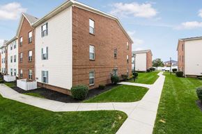Westerville apartment for rent - A pool surrounded by trees and chairs.