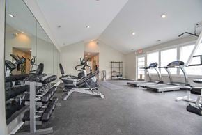 Westerville apartment for rent - A kitchen with white cabinets and black countertops.