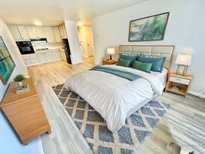 Denver apartment for rent - A long hallway with wood floors and white walls.