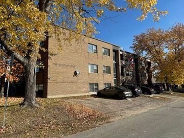 North Bay apartment for rent - A building with a parking lot in front of it.
